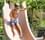 Thumbnail for A young boy slides down the Typhoon pool slide.