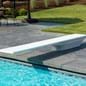 Thumbnail for A white Flyte-Deck II diving board on a swimming pool