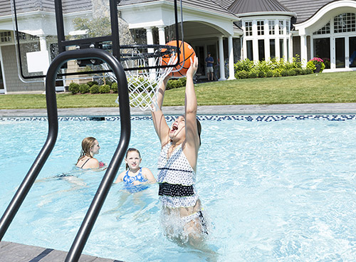 Girl Playing Basketball in Backyard In-Ground Swimming Pool with Pool Hoop